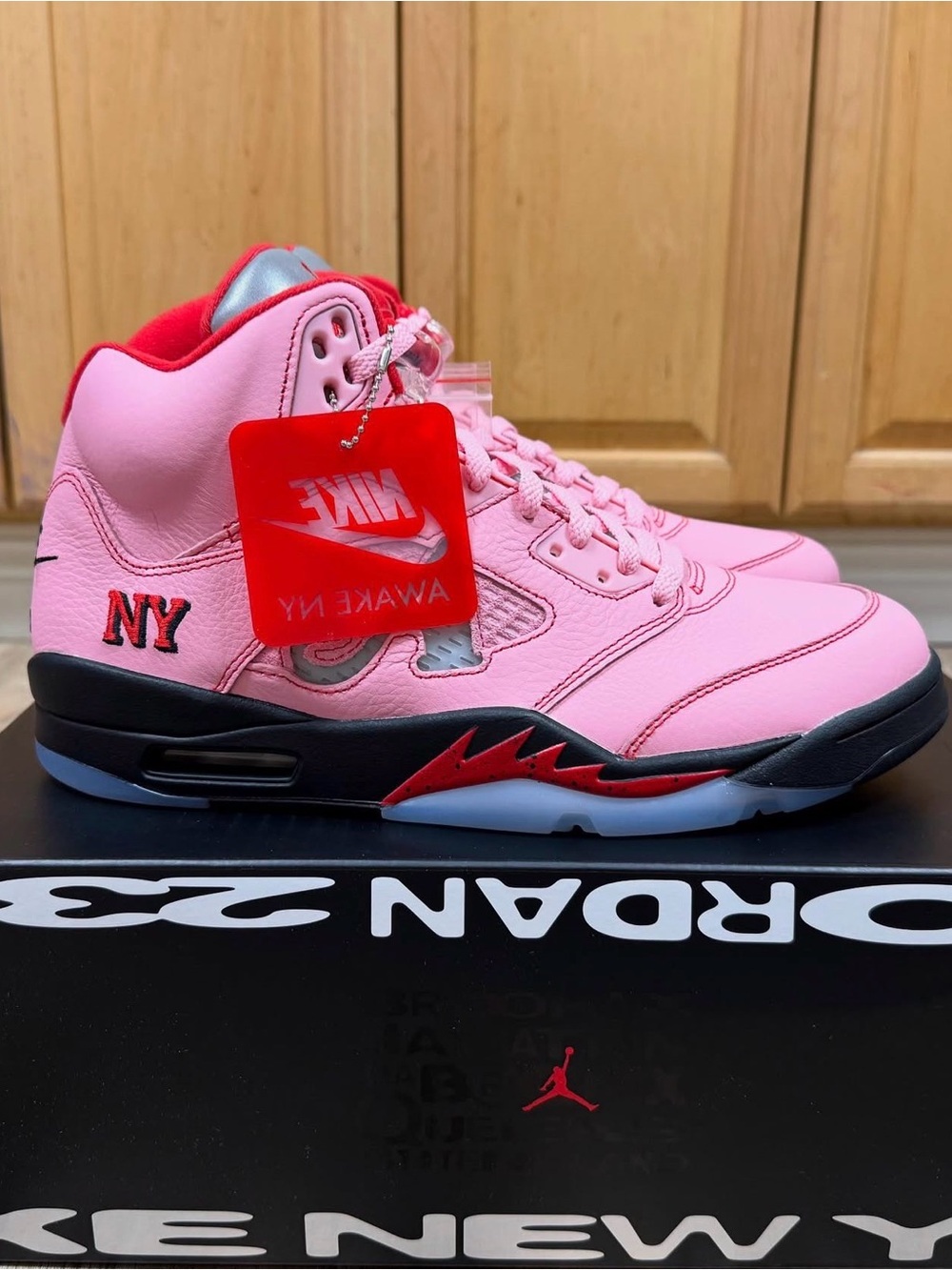 awake new york jordan 5
Pink and Red High-Top Sneakers with Black Midsole